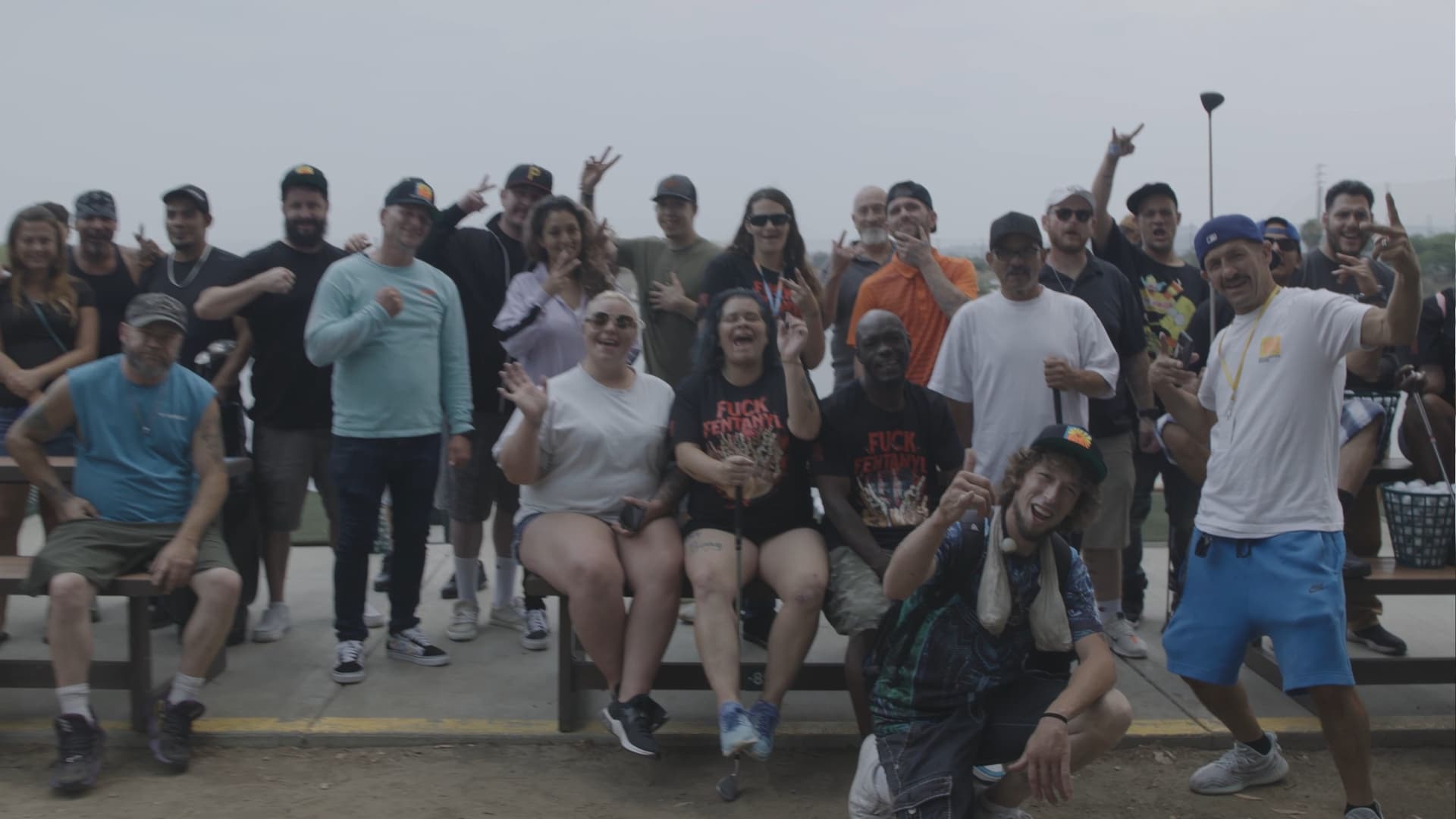 Large recovery group smiling outside the facility.