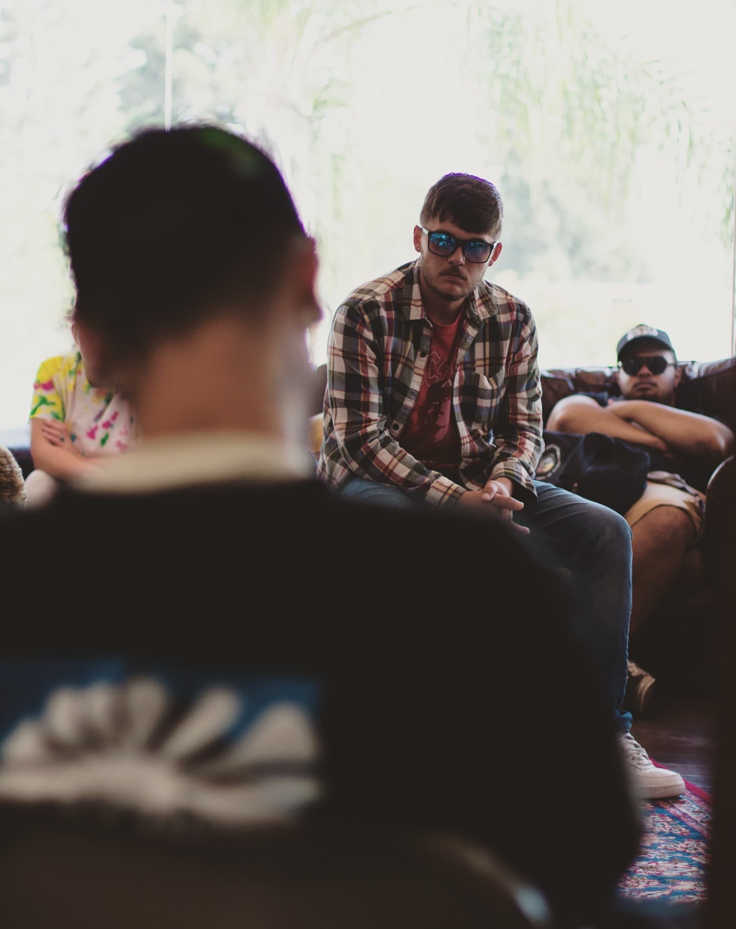 Clients in sunglasses sitting together and talking outdoors.