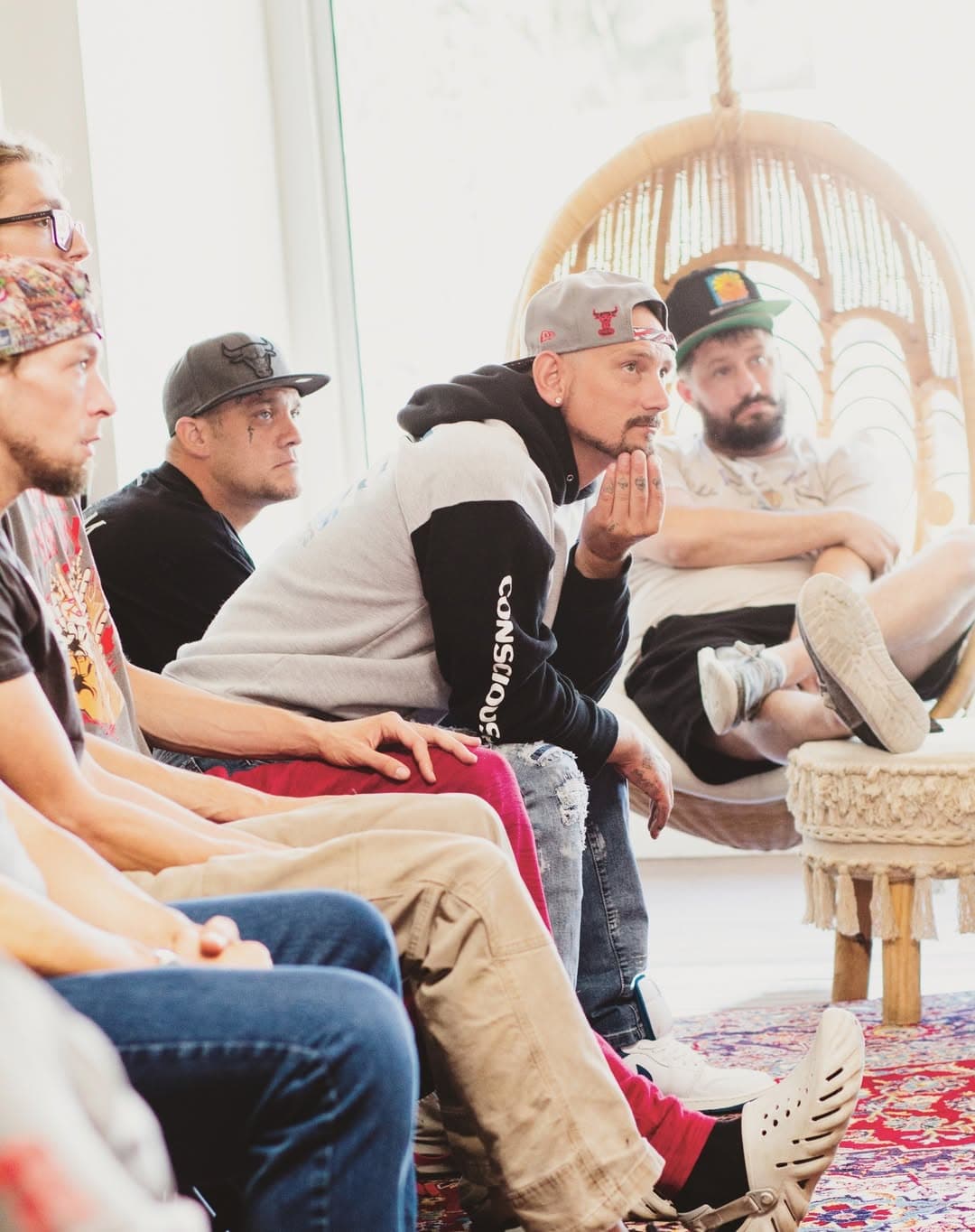 Large circle of men engaged in a group session.